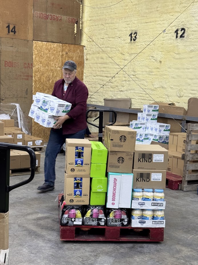 Volunteer loading boxes in warehouse